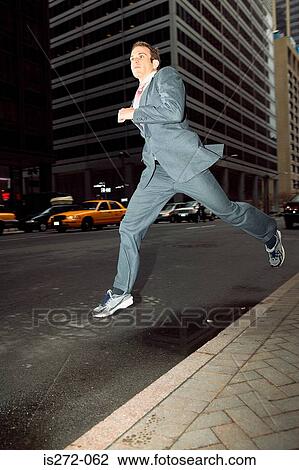 Businessman running through city View Large Photo Image Stock Image - Businessman running through city. Fotosearch