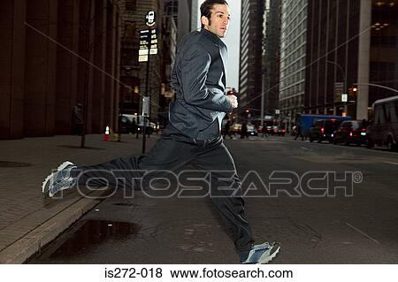 Businessman running through city View Large Photo Image Stock Photo - Businessman running through city. Fotosearch