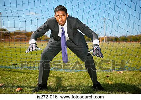 Stock Photograph - Businessman standing in goal. Fotosearch