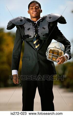 Businessman wearing american football uniform View Large Photo Image Stock Image - Businessman wearing american football uniform. Fotosearch