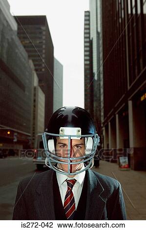 Businessman wearing an american football helmet View Large Photo Image Stock Image - Businessman wearing an american football helmet. Fotosearch