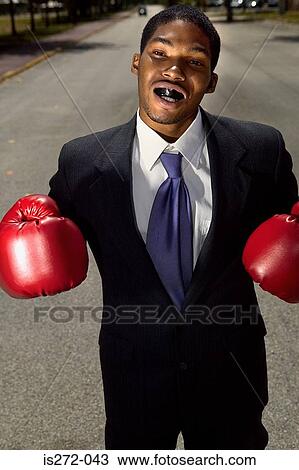 Businessman wearing boxing gloves View Large Photo Image Stock Image - Businessman wearing boxing gloves. Fotosearch