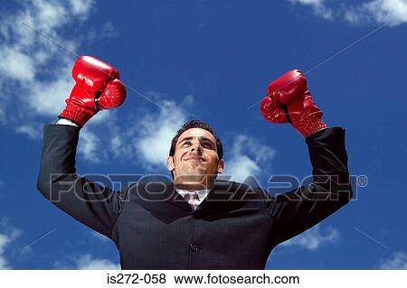 Stock Photo - Businessman wearing boxing gloves. Fotosearch