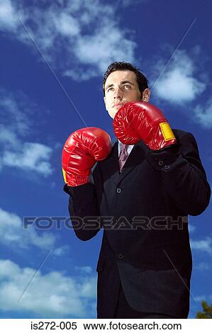 Businessman wearing boxing gloves View Large Photo Image Stock Photography - Businessman wearing boxing gloves. Fotosearch