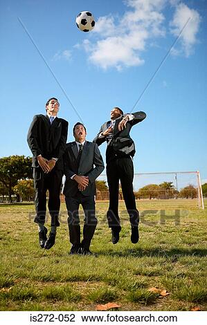 Businessmen jumping for football View Large Photo Image Stock Image - Businessmen jumping for football. Fotosearch