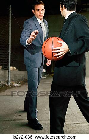 Stock Photograph - Businessmen playing basketball. Fotosearch