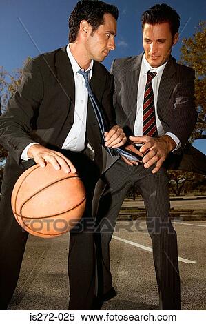 Stock Photography - Businessmen playing basketball. Fotosearch