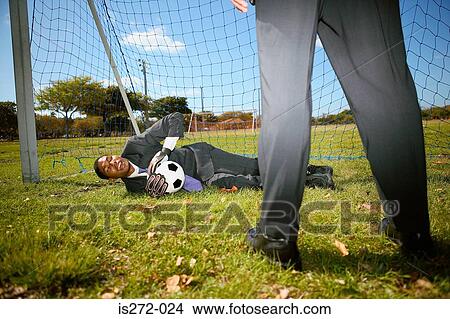 Businessmen playing football View Large Photo Image Picture - Businessmen playing football. Fotosearch