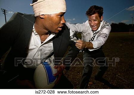 Stock Photo - Businessmen playing rugby. Fotosearch