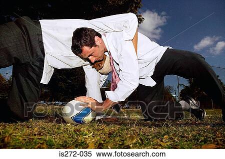 Businessmen playing rugby View Large Photo Image Stock Photography - Businessmen playing rugby. Fotosearch
