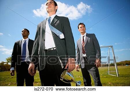 Stock Image - Businessmen with trophy. Fotosearch