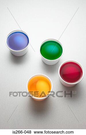 Eggs in cups of paint View Large Photo Image Stock Photo - Eggs in cups of paint. Fotosearch