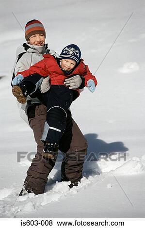Brothers playing in snow View Large Photo Image Stock Photo - Brothers playing in snow. Fotosearch