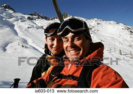 Couple on a ski lift View Large Photo Image Stock Image - Couple on a ski lift. Fotosearch