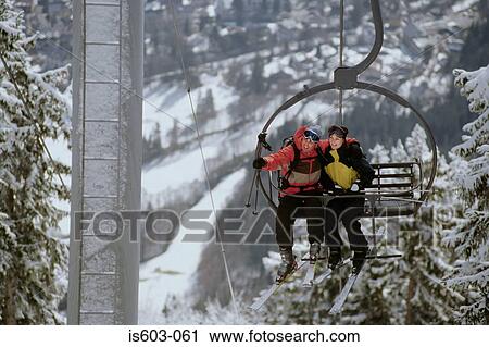 Couple on a ski lift View Large Photo Image Stock Image - Couple on a ski lift. Fotosearch