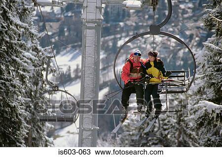 Couple on a ski lift View Large Photo Image Stock Image - Couple on a ski lift. Fotosearch