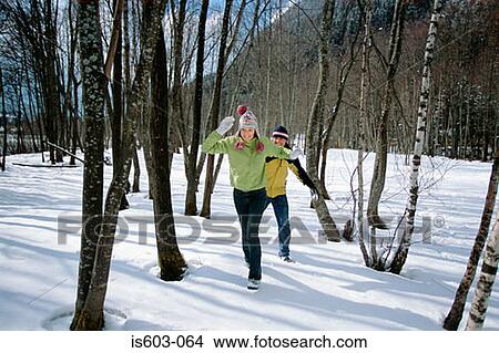 Couple playing in snow View Large Photo Image Picture - Couple playing in snow. Fotosearch