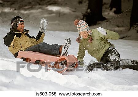 Couple playing in snow View Large Photo Image Stock Photo - Couple playing in snow. Fotosearch
