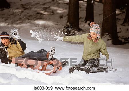 Couple playing in snow View Large Photo Image Stock Photo - Couple playing in snow. Fotosearch