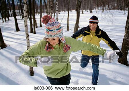 Couple playing in snow View Large Photo Image Stock Photograph - Couple playing in snow. Fotosearch