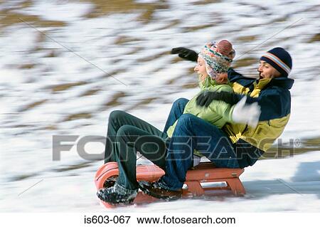 Couple riding a sleigh View Large Photo Image Stock Photo - Couple riding a sleigh. Fotosearch