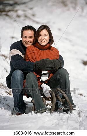 Couple sitting on sleigh View Large Photo Image Stock Photograph - Couple sitting on sleigh. Fotosearch