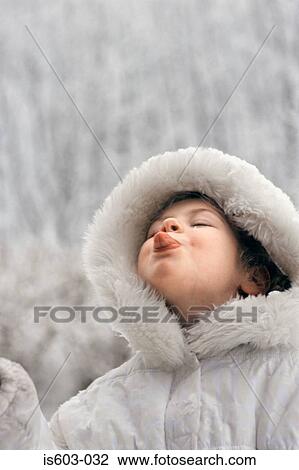 Girl catching snow on tongue View Large Photo Image Stock Image - Girl catching snow on tongue. Fotosearch