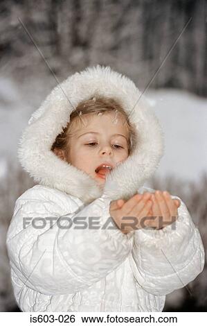 Girl holding catching snow in hands View Large Photo Image Stock Photograph - Girl holding catching snow in hands. Fotosearch