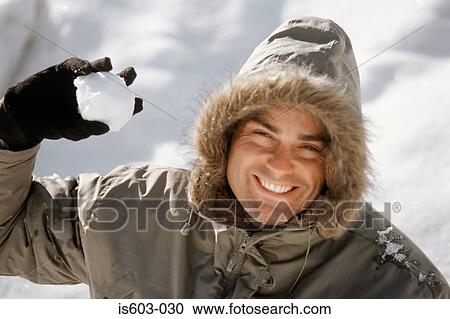 Man holding a snowball View Large Photo Image Stock Image - Man holding a snowball. Fotosearch