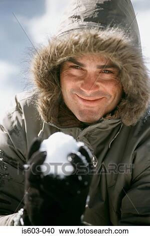 Man holding a snowball View Large Photo Image Stock Image - Man holding a snowball. Fotosearch