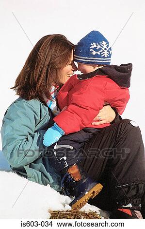 Mother and son hugging in snow View Large Photo Image Picture - Mother and son hugging in snow. Fotosearch