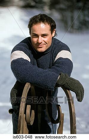 Stock Photo - Portrait of a man with a sleigh. Fotosearch