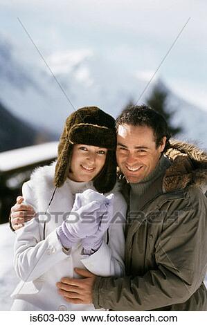 Portrait of couple with snowball View Large Photo Image Stock Photo - Portrait of couple with snowball. Fotosearch