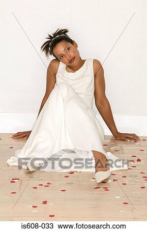 Stock Image - Bride sitting on wooden floor. Fotosearch
