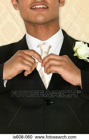 Bridegroom adjusting necktie View Large Photo Image Stock Image - Bridegroom adjusting necktie. Fotosearch