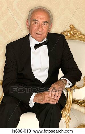 Stock Image - Elderly man sitting in armchair. Fotosearch