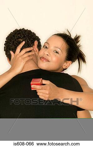Stock Photograph - Engaged young couple. Fotosearch