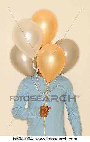 Man holding a bunch of balloons View Large Photo Image Picture - Man holding a bunch of balloons. Fotosearch