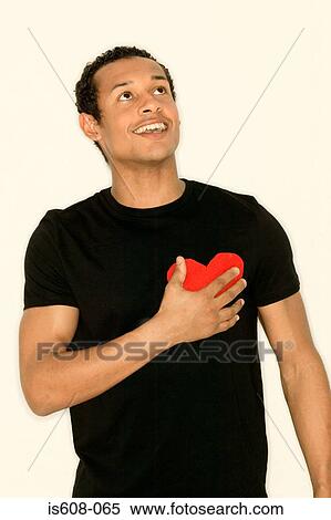 Stock Photography - Man with heart shape on t-shirt. Fotosearch