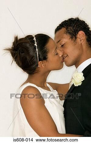 Picture - Newlywed couple kissing. Fotosearch