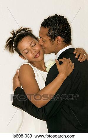 Stock Photo - Newlywed couple kissing. Fotosearch