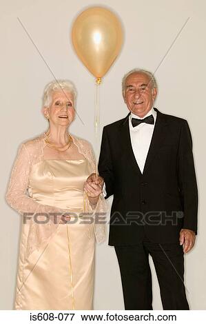 Senior couple holding a balloon View Large Photo Image Stock Photo - Senior couple holding a balloon. Fotosearch