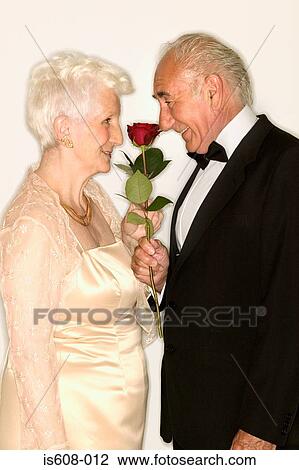 Senior couple sniffing rose View Large Photo Image Stock Image - Senior couple sniffing rose. Fotosearch