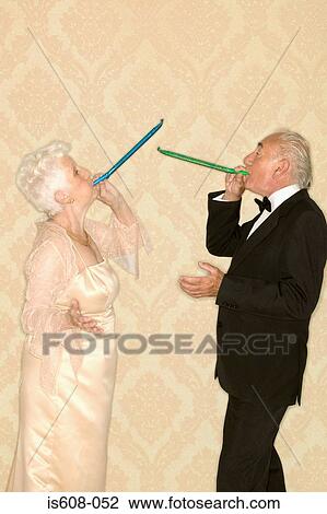 Senior couple with party horns View Large Photo Image Stock Image - Senior couple with party horns. Fotosearch