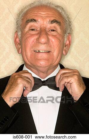 Stock Image - Senior man adjusting bow tie. Fotosearch