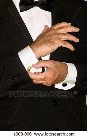 Stock Photograph - Senior man adjusting cuff links. Fotosearch