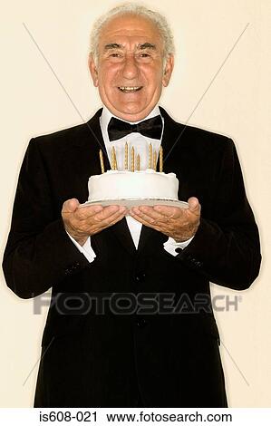 Senior man holding a birthday cake View Large Photo Image Stock Image - Senior man holding a birthday cake. Fotosearch