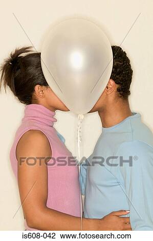 Stock Image - Young couple kissing. Fotosearch