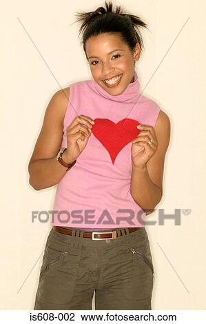 Young woman holding a heart shape View Large Photo Image Stock Image - Young woman holding a heart shape. Fotosearch