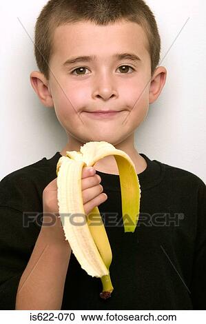 Boy eating a banana View Large Photo Image Stock Image - Boy eating a banana. Fotosearch
